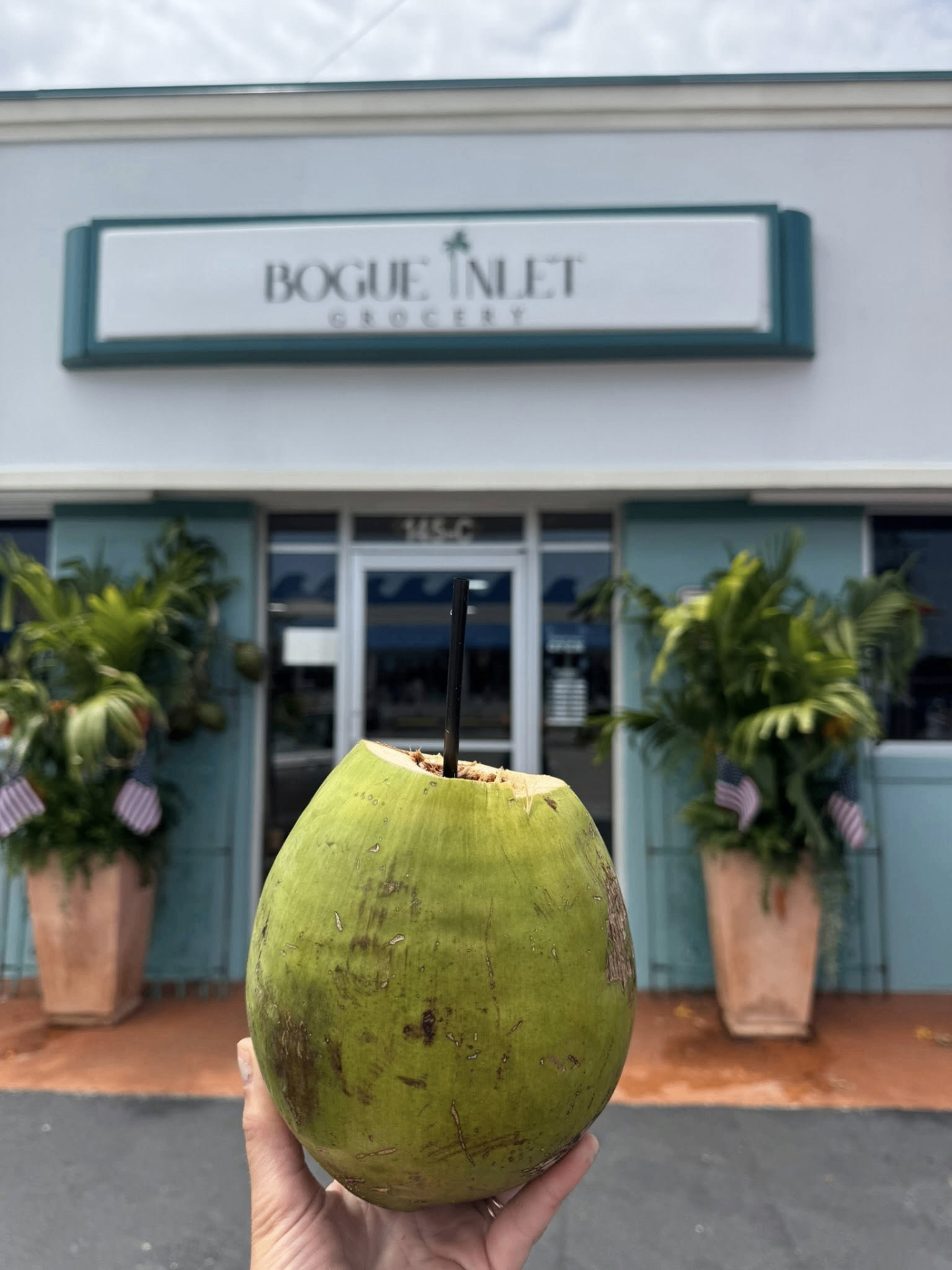 Fresh coconut in front of Bogue Inlet Grocery storefront
